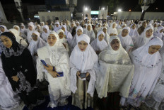 Women attend a mass prayer on Aug. 14, 2025, at Baiturrahman Grand Mosque in provincial capital Banda Aceh to commemorate the 20th anniversary of the Aceh peace agreement.