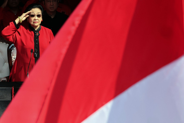 Indonesian Democratic Party of Struggle (PDI-P) chair Megawati Soekarnoputri salutes the Red-and-White Flag during an Independence Day ceremony on Aug. 17 at party headquarters in Jakarta. Megawati, a former president, decided to forego the Independence Day ceremony at the Merdeka Palace to attend one held by her party.