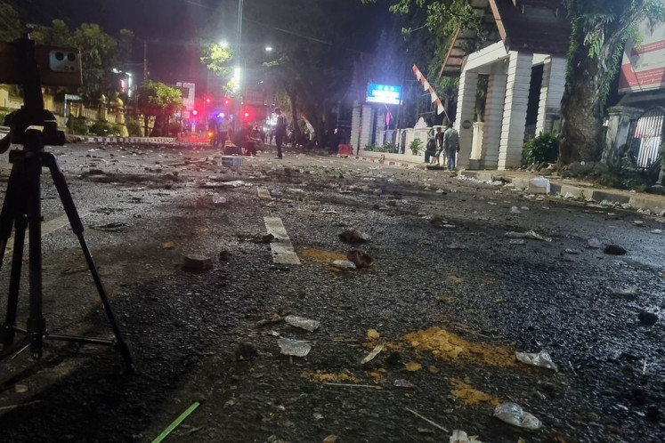 The street in front of Bone Regency office in South Sulawesi, is left with debris on Tuesday night, August 19, 2025, after a property tax protest turns violent hours earlier. 