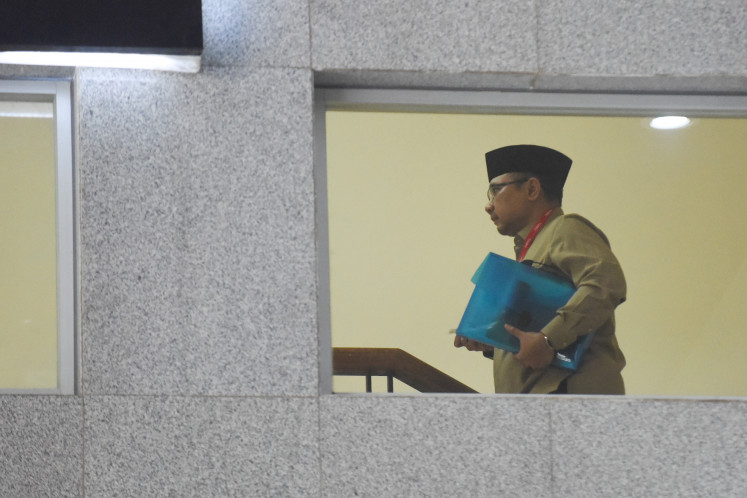 Former religious affairs minister Yaqut Cholil Qoumas climbs the stairs in the South Jakarta headquarters of the Corruption Eradication Commission (KPK) on Aug. 7 to attend his questioning.