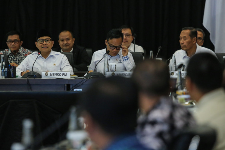 Deputy Manpower Minister Immanuel Ebenezer (center) sits next to Coordinating Social Empowerment Minister Muhaimin Iskandar (left) and Deputy Higher Education, Science and Technology Minister Fauzan (right) during a meeting in Jakarta on July 28, 2025.