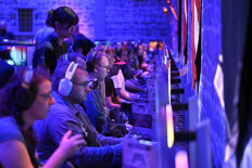Gamers wait for the “Crimson Desert“ video game of Pearl Abyss at the Gamescom video games trade fair at the Trade Fair Center in Cologne, western Germany, on Aug. 21, 2025. The 2025 edition of the vast Gamescom trade fair in Cologne, Germany, had its opening night on Aug. 19, 2025 and will be running from Aug. 20 to 24, 2025.