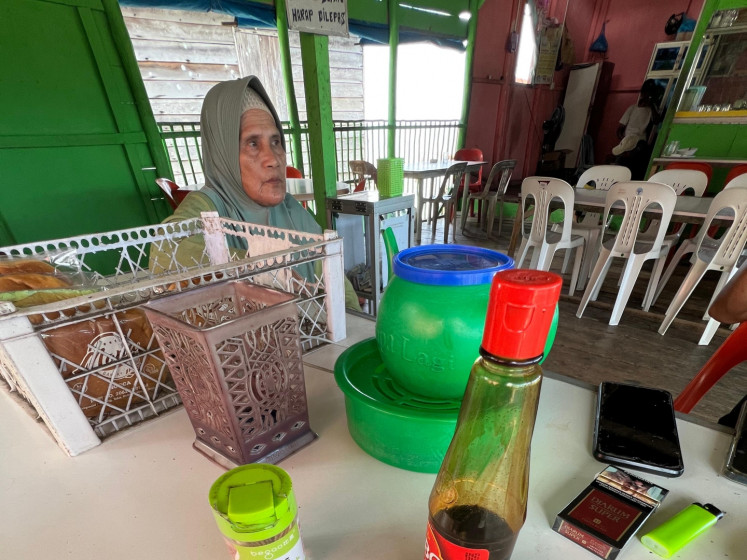 Siti “Nek Hawe” Hawa, a community leader of Sembulang village on Rempang Island in Batam regency, Riau Islands, sits in a local café on Aug. 21, 2025. She has expressed concern that, as with the Rempang Eco-City development project, the government did not consult the local community on its latest plan to treat wounded Palestinians at the Galang Island Infectious Disease Hospital (RSKI).