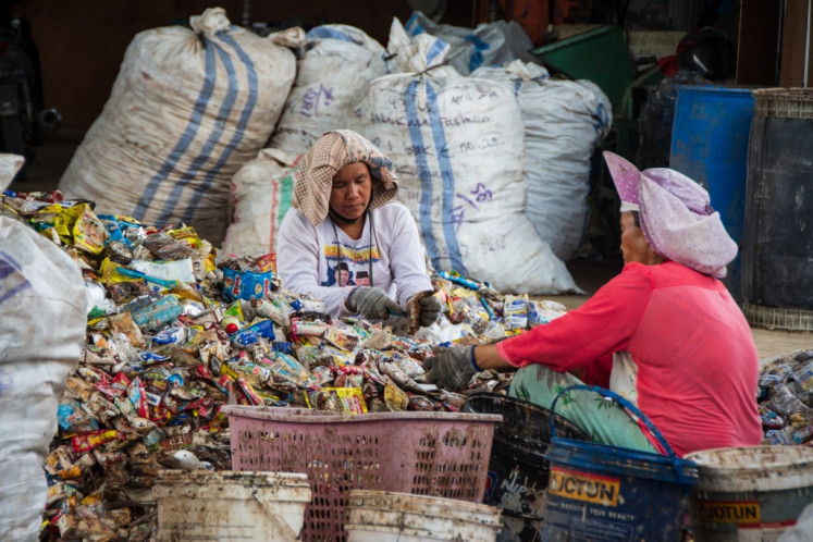 Women sort plastic waste on Aug. 8, 2025, at a Petasol production facility in Pekanbaru, Riau. It is one of more than 50 such facilities deployed nationwide to produce Petasol, a diesel-equivalent fuel developed by the National Research and Innovation Agency (BRIN) to support the government’s sustainable energy and plastic waste management agenda.