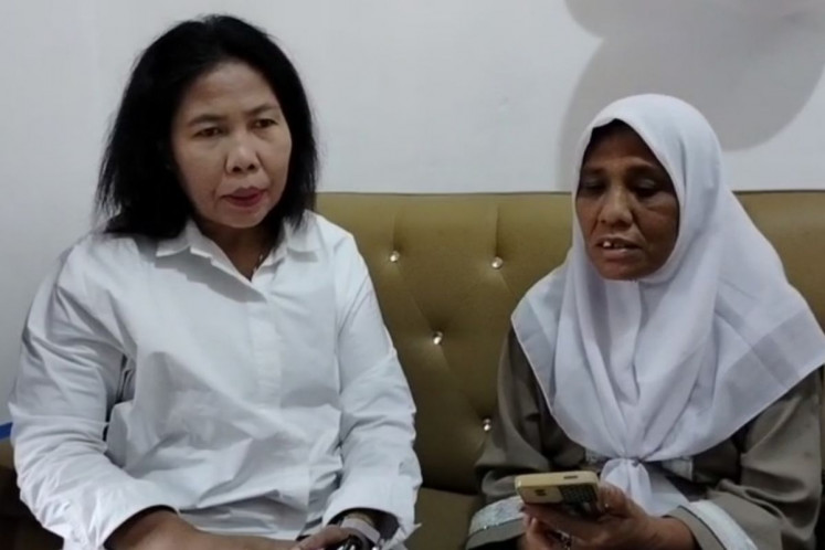 North Sumatra Indonesian Migrant Workers Protection and Service Agency (BP3MI) official, Sumarni Sinambela (left) receives a report filed by Lanniari Hasibuan in Medan on Aug. 21, 2025. Lanniari reported that her daughter Nazwa Aliya had died while working in Cambodia on Aug. 12, 2025, and requested assistance in bringing her body home. 