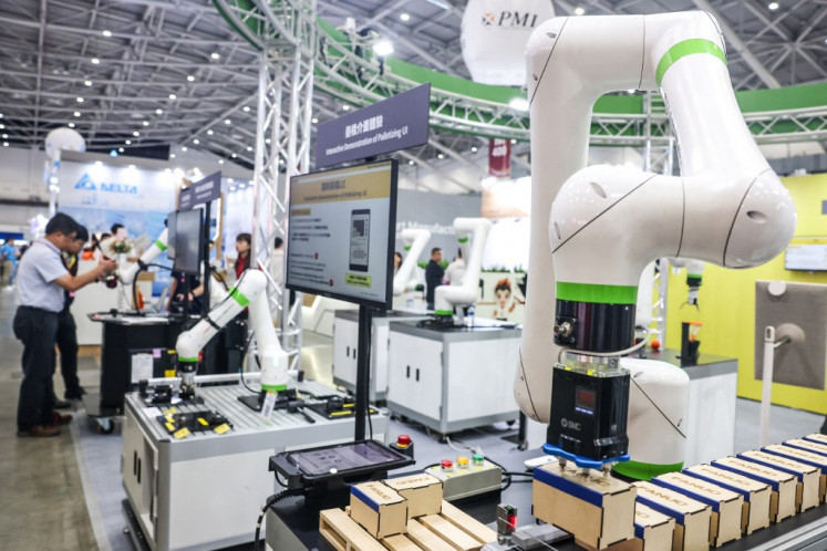 Robotic arms made by Taiwanese company FANUC Corporation are displayed on Aug. 20 during the Taiwan Automation Intelligence and Robot Show 2025 in Taipei.