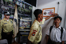 Job seekers undergo a height test to apply for company security guard positions at JobFest 2025 on Aug. 19, 2025, at the Jakarta International Velodrome.