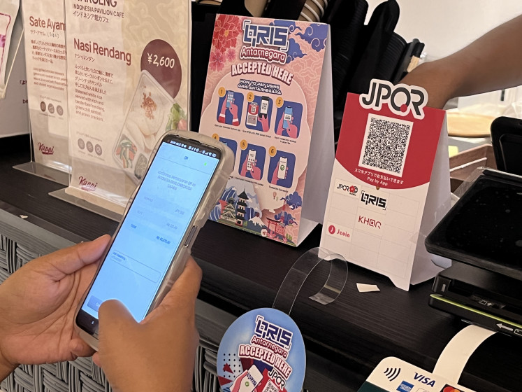 A customer scans a code of Japan's Unified QR Code (JPQR) to make a payment using the Quick Response Indonesia Standard (QRIS) at the World Expo 2025 on Aug. 25 in Osaka, Japan.