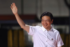 Singaporean Prime Minister Lawrence Wong waves to supporters of his People's Action Party (PAP) on May 3, 2025, as he arrives at the PAP’s election watch party.