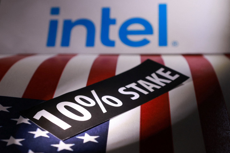 A US flag and the Intel logo are seen in this illustration taken Aug. 22, 2025, to illustrate the White House's acquisition of a near-10 percent stake in the chipmaker.