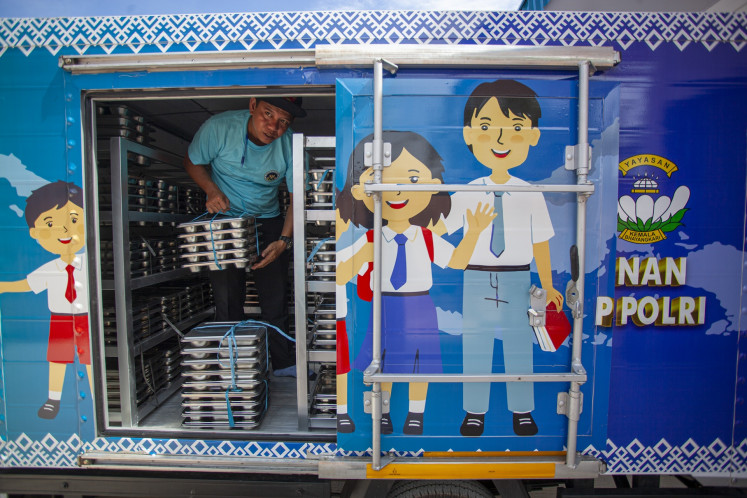 A worker sets meal packages to be distributed under the free nutritious meal initiative at a Nutrition Fulfillment Service Unit (SPPG) opened by the Riau Islands Police in Batam, Riau Islands, on Aug. 25, 2025.