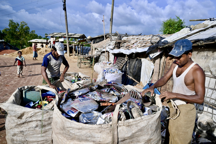 Rohingya refugees collect waste at the Balukhali camp in Ukhia, Cox's Bazar, Bangladesh on August 26, 2025. 