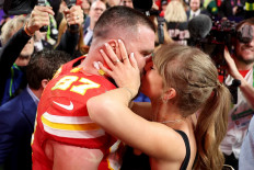 Travis Kelce #87 of the Kansas City Chiefs kisses Taylor Swift after defeating the San Francisco 49ers 25-22 in overtime during Super Bowl LVIII at Allegiant Stadium on February 11, 2024 in Las Vegas, US.