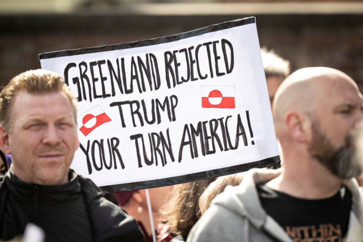 In this file photo taken on March 29, 2025 people protest against the American pressure taking place against Greenland and Denmark, in front of the American Embassy in Copenhagen. Denmark summoned the US charge d'affaires for talks on August 27, 2025 after reports of attempted interference in Greenland, a Danish autonomous territory which US President Donald Trump wants to control. 