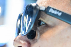 A man tries on artificial intelligence glasses on July 29 during the World Artificial Intelligence Conference (WAIC) at the Shanghai World Expo and Convention Center in Shanghai, China.