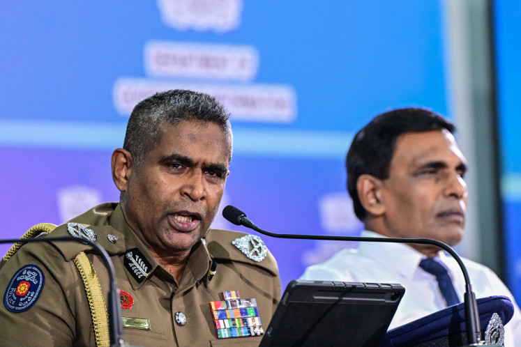 Sri Lanka's Inspector General of Police Priyantha Weerasooriya (left) speaks as Minister of Public Security Ananda Wijepala looks on during a press conference in Colombo on Aug. 28. Sri Lanka's most wanted man has been arrested in Indonesia and will be extradited to face charges including gunning down a rival inside a court, officials said Aug. 28.