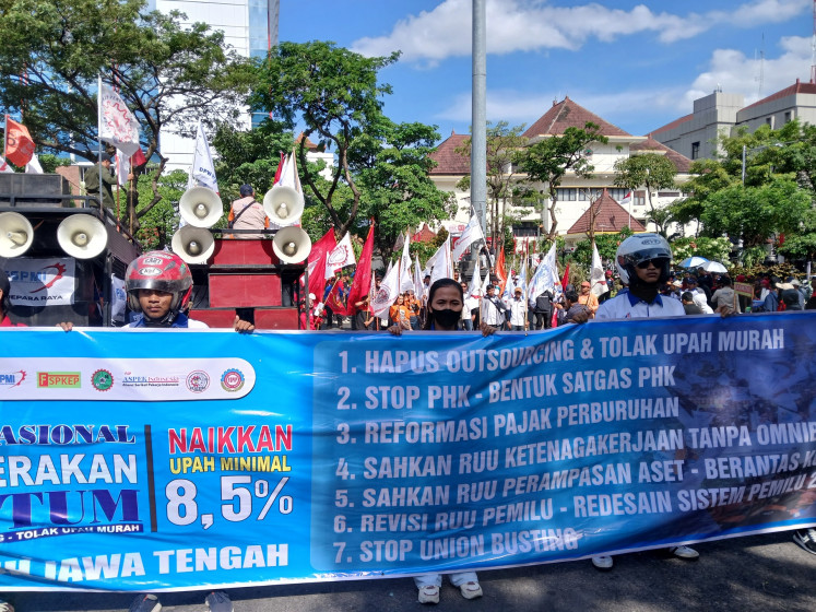 Hundreds of workers hold a rally demanding better working conditions and wages in front of the offices of Central Java Regional Representative Council (DPRD) and governor in Semarang, Central Java, on Aug. 28, 2025.