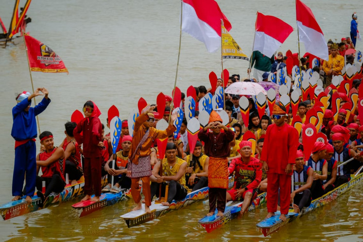 Participants of the century-old Pacu Jalur longboat racing festival in Kuantan Singingi regency, Riau, take a group photo on Aug. 24, 2025.