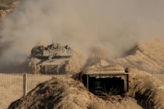 An Israeli army battle tank rolls in the Gaza Strip near border with southern Israel on August 29, 2025, amid the ongoing war between Israel and the Palestinian militant group Hamas. The Israeli military declared Gaza City “a dangerous combat zone“ on August 29, as it prepared to conquer the Palestinian territory's largest city after almost two years of war.