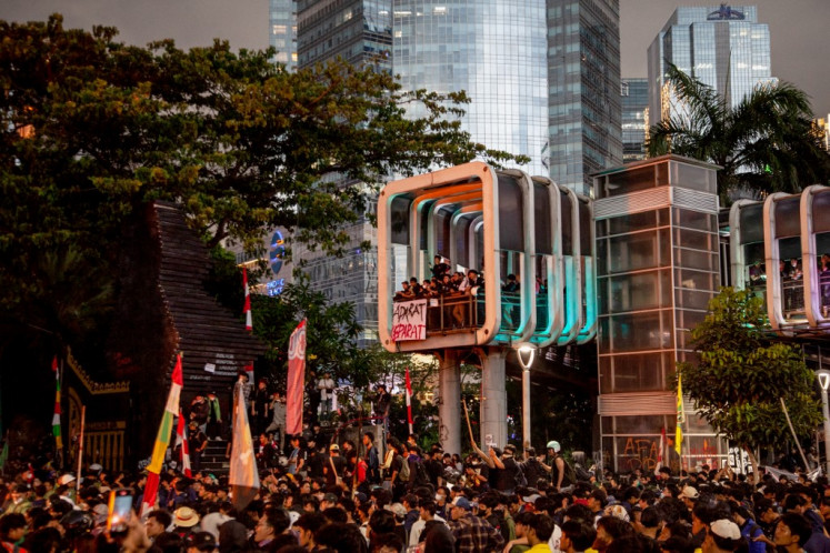 People take part in a protest against police in front of the Greater Jakarta Metropolitan Regional Police headquarters in Jakarta on August 29, 2025.