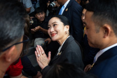 Thailand's sacked prime minister Paetongtarn Shinawatra (center) greets supporters as she arrives at the Pheu Thai Party headquarters after her dismissal by the Constitutional Court in Bangkok on Aug. 29, 2025. Thailand's Constitutional Court sacked prime minister Paetongtarn and her cabinet on Aug. 29 over her handling of the country's border row with Cambodia, throwing the kingdom into political turmoil.