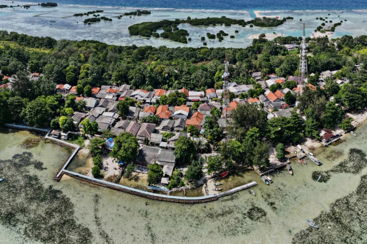 In this aerial picture taken on February 22, 2023, a concrete embankment, used to stem rising sea levels, is seen around part of Pari island in the Thousand Islands cluster. 