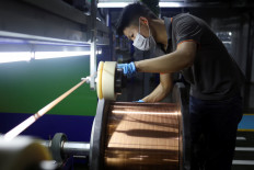 An employee works on the production line for copper flat wire at the Wellascent factory in Ganzhou, Jiangxi province, China, on Aug. 14, 2025.