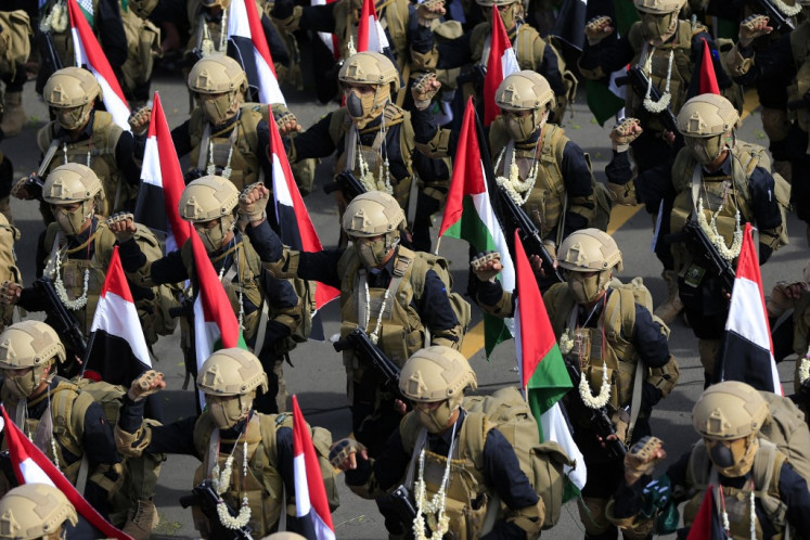 Yemeni soldiers carry Palestinian flags during a rally in solidarity with Palestinians and in condemnation of Israel and the US, in the Huthi-run capital Sanaa on August 29, 2025.
