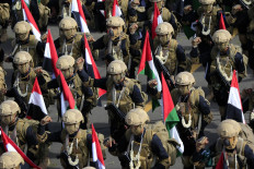 Yemeni soldiers carry Palestinian flags during a rally in solidarity with Palestinians and in condemnation of Israel and the US, in the Huthi-run capital Sanaa on August 29, 2025.
