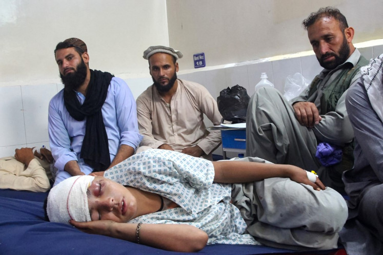 An injured Afghan boy (bottom) receives treatment at a hospital after an earthquake in Afghanistan's Jalalabad on September 1, 2025. 