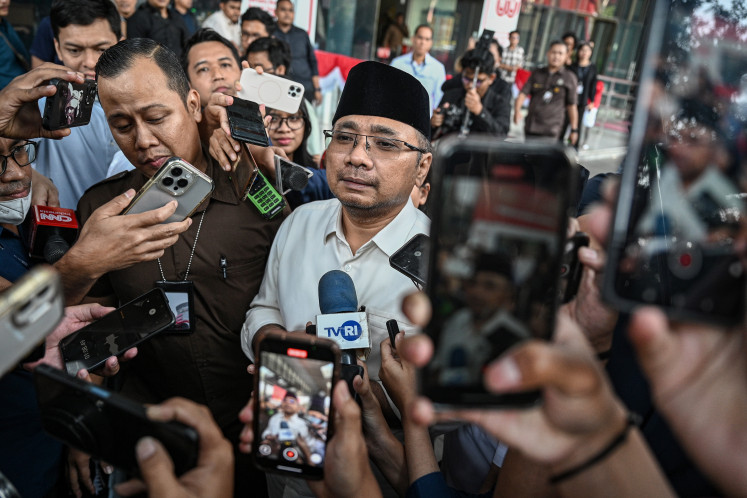 Yaqut Cholil Qoumas (center, in white shirt) leaves the South Jakarta headquarters of the Corruption Eradication Commission (KPK) on Sept. 1, 2025, following his second interrogation as a witness in an ongoing probe into alleged misallocation of the haj quota in 2024, when he was religious affairs minister.