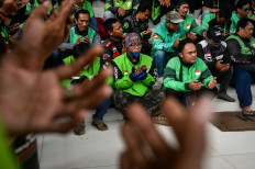 Online motorcycle transportation drivers pray for late fellow driver Affan Kurniawan during a peace declaration at the South Tangerang Regional Legislative Council (DPRD) office in Banten, on Sept. 1, 2025. 