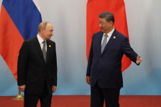 Chinese President Xi Jinping (right) shows the way to Russian President Vladimir Putin after the photo session of the Shanghai Cooperation Organization (SCO) Summit 2025 at the Meijiang Convention and Exhibition Center in Tianjin on September 1, 2025.