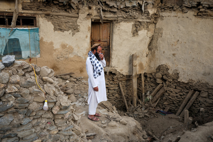 An Afghan man reacts as he stands amidst the rubble of a collapsed house after a deadly magnitude-6 earthquake that struck Afghanistan around midnight, in Dara Noor, in Jalalabad, Afghanistan, September 1, 2025. 