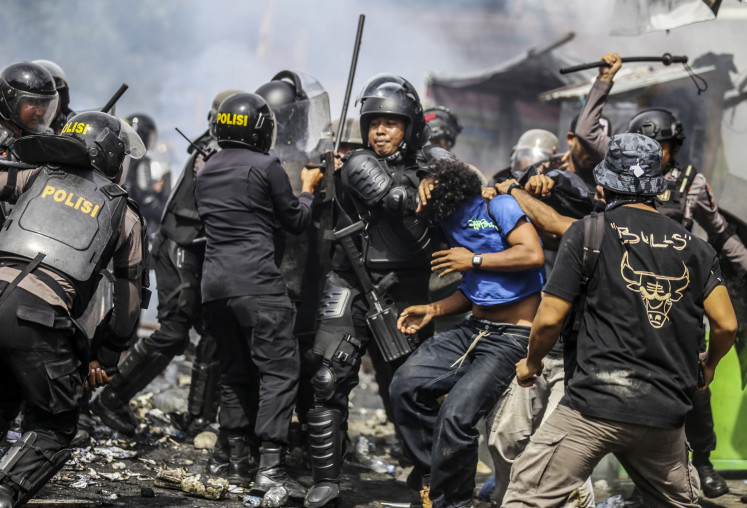 Ternate Police arrest a university student during a protest in front of the Ternate Legislative Council (DPRD) building on Sept. 1 in North Maluku. Police dispersed protestors after a protest against House of Representatives members' lavish allowances and the killing of a ride-hailing driver by a police vehicle.