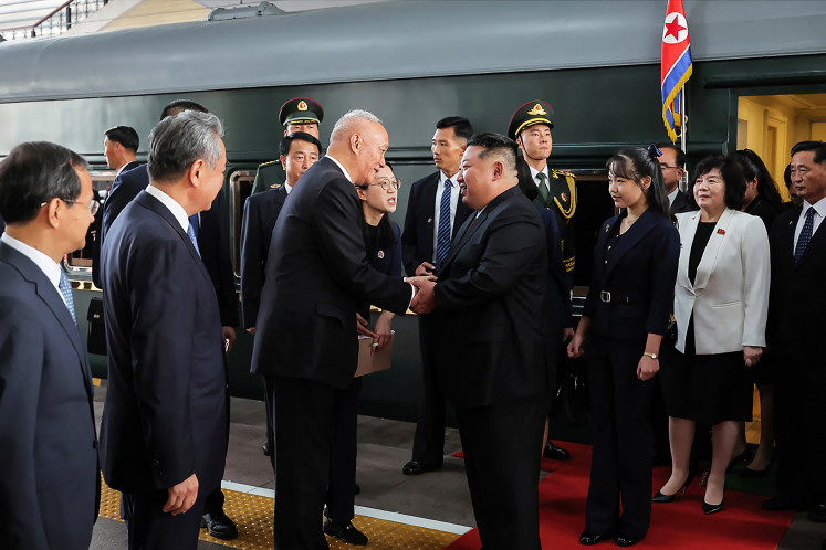 This photograph taken on September 2, 2025 and released by Korean Central News Agency (KCNA) via KNS shows North Korea's leader Kim Jong Un (center right) and his daughter Kim Ju Ae (third right) being greeted by China's Secretary of the Central Secretariat of the Communist Party Cai Qi (center left) and Foreign Minister Wang Yi (second left) upon their arrival at the Beijing Railway Station. Kim arrived in Beijing by armored train ahead of a military parade on September 3, celebrating the end of World War II.