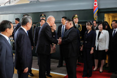This photograph taken on September 2, 2025 and released by Korean Central News Agency (KCNA) via KNS shows North Korea's leader Kim Jong Un (center right) and his daughter Kim Ju Ae (third right) being greeted by China's Secretary of the Central Secretariat of the Communist Party Cai Qi (center left) and Foreign Minister Wang Yi (second left) upon their arrival at the Beijing Railway Station. Kim arrived in Beijing by armored train ahead of a military parade on September 3, celebrating the end of World War II.