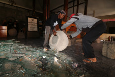 Authorities move ancient artifacts at the Bagawanta Bhari Museum in Kediri regency, East Java, on Aug. 31, 2025, one day after rioters ransacked the museum and stole parts of its collection. 