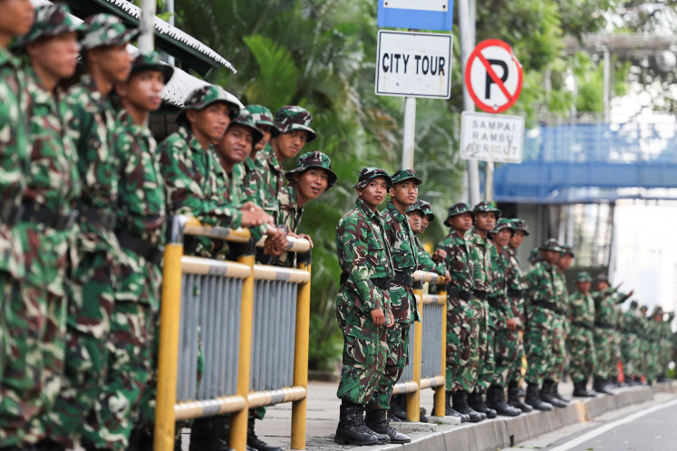 Indonesian Military (TNI) personnel stand guard on the street outside the National Monument (Monas) complex, amid the widespread anti-government protests and rioting over issues such as extra pay for lawmakers and their housing allowances that resulted in riots which escalated after a motorcycle taxi (ojol) driver was killed under a police vehicle, in Jakarta on September 2, 2025.