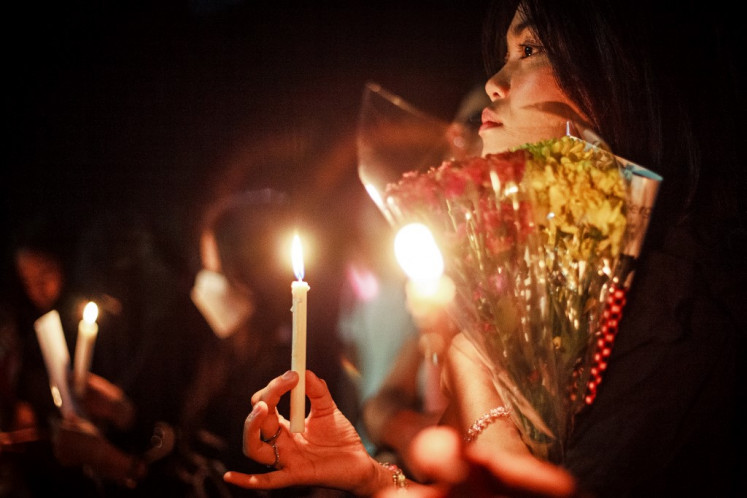Students hold candles at the University of Indonesia campus in Depok, West Java on September 3, 2025, as they pay tribute to victims killed during a clash between police and demonstrators demanding police reform and termination of lawmakers' excessive salaries. 