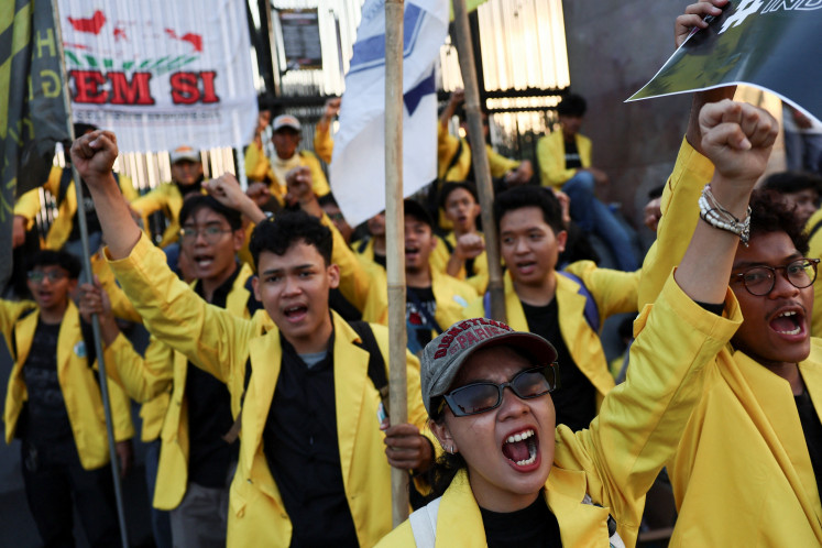 University students shout slogans during a protest demanding the release of demonstrators detained during the widespread protests over lawmakers' extra pay and housing allowances, which escalated after a police armored vehicle hit and killed a driver of a ride-hailing motorbike, near the House of Representatives building in Jakarta, September 4, 2025. 