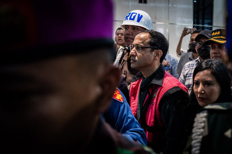 Former education, culture, research and technology minister Nadiem Makarim (center) walks out of the Attorney General's Office (AGO) building in Jakarta on Sept. 4, 2025. The AGO named former education, culture, research and technology minister Nadiem Makarim a suspect in a corruption case pertaining to the procurement of Chromebook laptops for schools across the country during his ministerial tenure, which was estimated to have caused around Rp 1.9 trillion (US$11 million) in state losses.