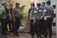 Comr. Cosmas Kaju Gae (fifth left), commander of the National Police Mobile Brigade's (Brimob) Fourth Pelopor Regiment Battalion A, is escorted out of the National Police's Transnational Crime Center building in Jakarta on Sept. 3, 2025. An ethics hearing dishonorably discharged Cosmas after finding him guilty of committing a serious ethical violation that caused the death of 21-year-old motorcycle transportation driver Affan Kurniawan during a violent protest in Jakarta on Aug. 28, 2025.