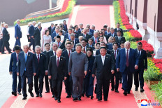 Chinese President Xi Jinping (center, front row) walks with Russian President Vladimir Putin (left, front row) and North Korean leader Kim Jong Un (right, front row) as they lead a group of other officials to attend the 80th Victory Day parade military parade in Beijing's Tiananmen Square on Sept. 3, 2025, in this picture released on Sept. 4 by the Korean Central News Agency (KCNA) of North Korea.
