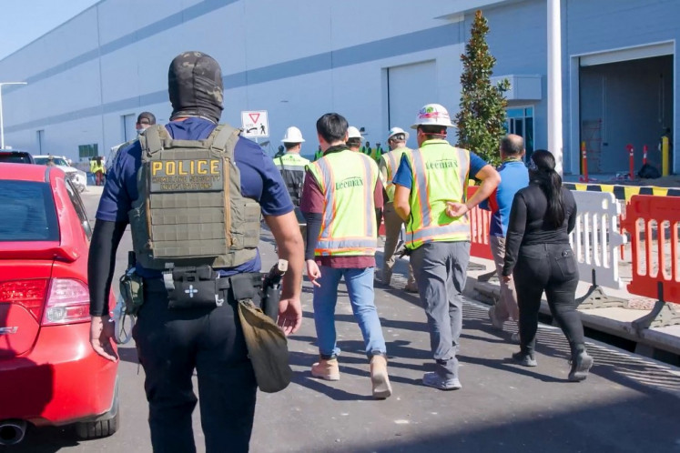 This handout photo released by US Immigration and Customs Enforcement (ICE) on Sept. 5, 2025, shows a Homeland Security Investigations police officer during a federal search warrant at a company in Ellabell, Georgia, on Sept. 4, 2025. More than 300 South Koreans were among 475 people arrested by US immigration officials in a raid on a Hyundai-LG battery plant being built in the southern US state of Georgia, the foreign minister in Seoul said on on Sept. 6, 2025.