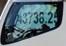 A stock quotation board showing the Nikkei share average outside a brokerage is seen through a truck's window in Tokyo on Sept. 8, 2025.