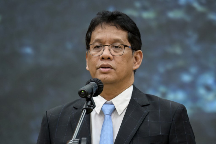 Newly appointed Finance Minister Purbaya Yudhi Sadewa sings the national anthem during the handover ceremony from his predecessor Sri Mulyani Indrawati at the Finance Ministry in Jakarta on September 9, 2025.