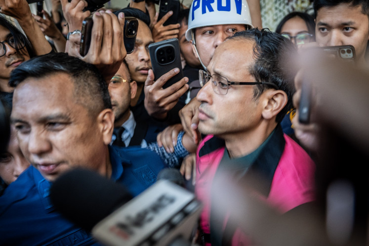 Former education, culture, research and technology minister Nadiem Makarim (center) walks out of the Attorney General's Office (AGO) building in Jakarta on Sept. 4, 2025. The AGO name him a suspect in a corruption case pertaining to the procurement of Chromebook laptops for schools across the country during his ministerial tenure which was estimated to have caused around Rp 1.9 trillion of state losses.