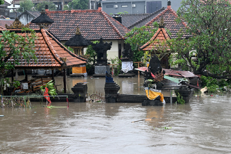 A Hindu temple is inundated by floodwaters following heavy rain in Denpasar, Indonesia's Bali island, on September 10, 2025.