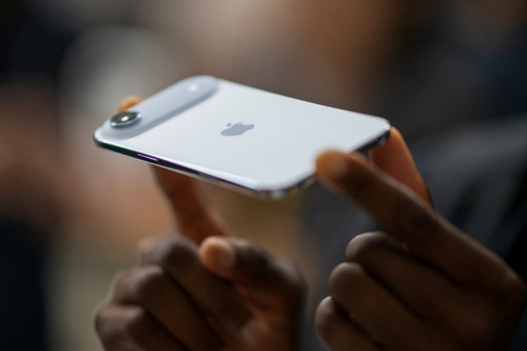 A person holds an Apple iPhone Air during Apple's “Awe-Dropping“ event at the Steve Jobs Theater on the Apple Park campus in Cupertino, California, on September 9, 2025. 